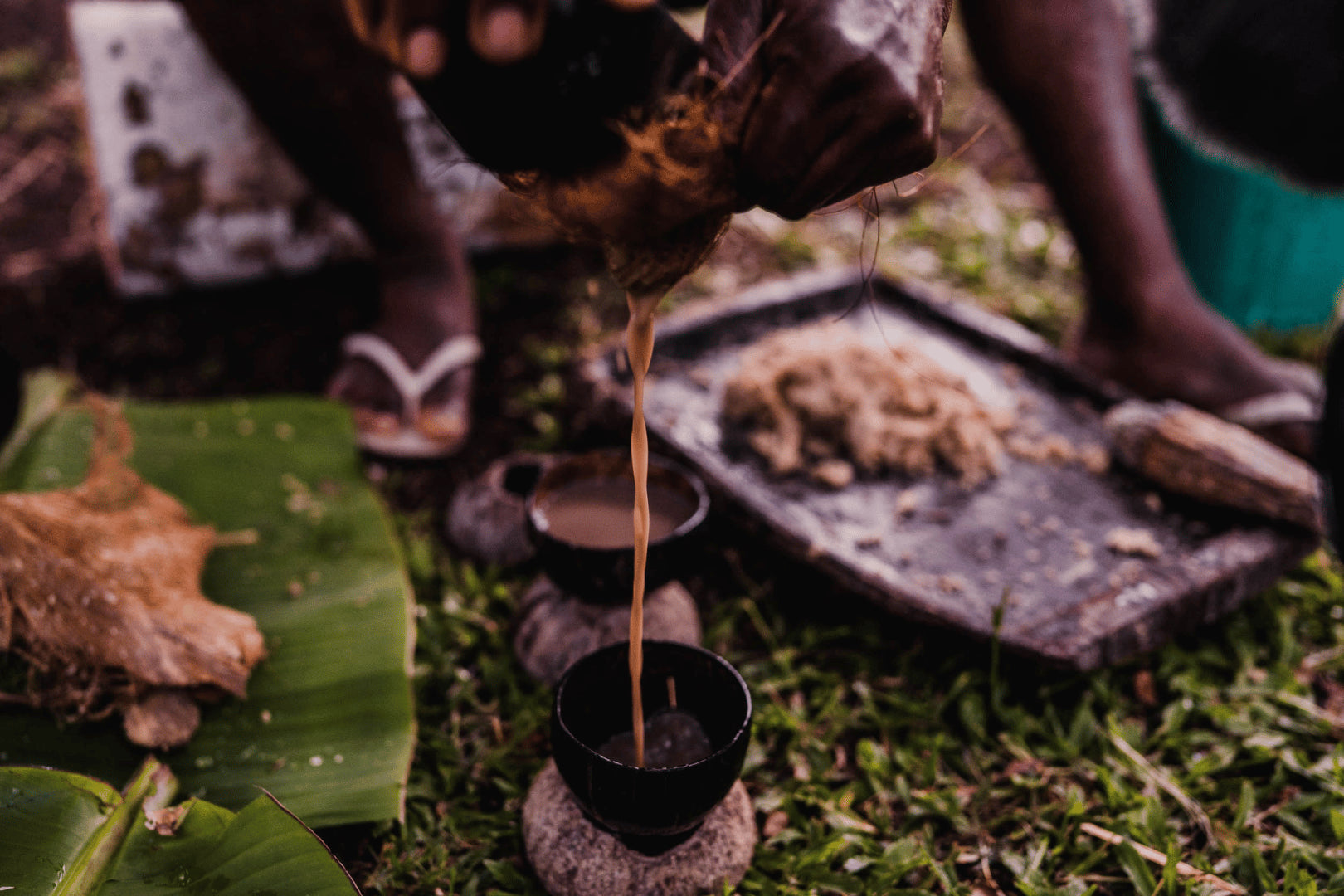 Traditional preparation of kava being poured into bowls, highlighting the cultural and natural process of making kava