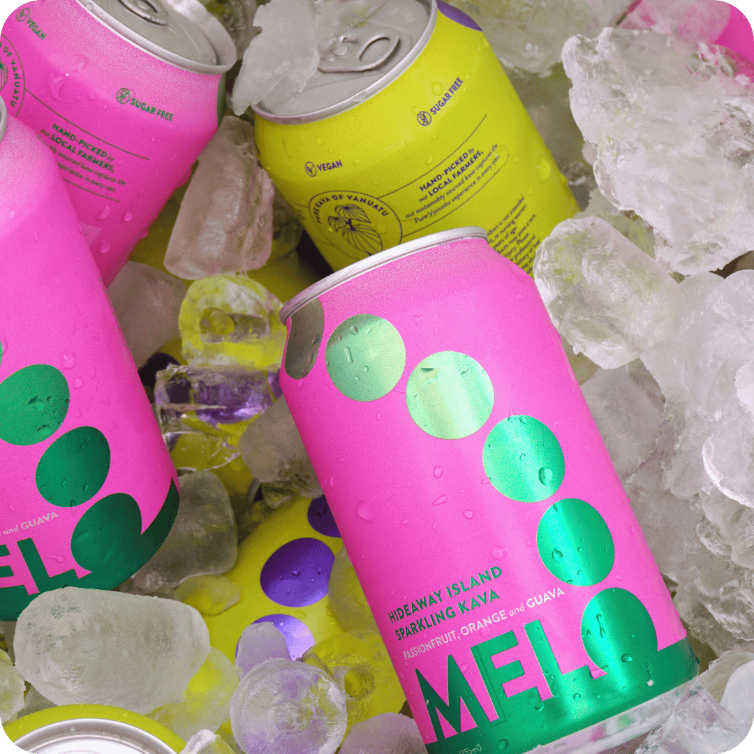 Close-up of Melo sparkling kava cans—Passionfruit, Orange & Guava, and Banana Cream flavors—nestled in ice, highlighting their refreshing and vibrant appeal.